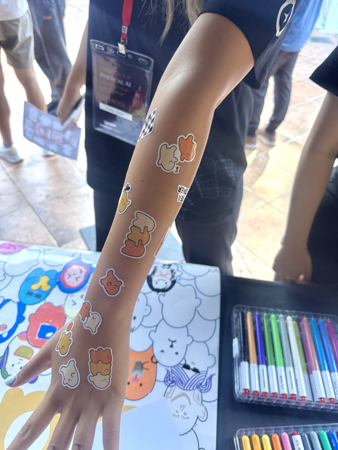 dazi character tattoos along a visitor's arm at an event booth